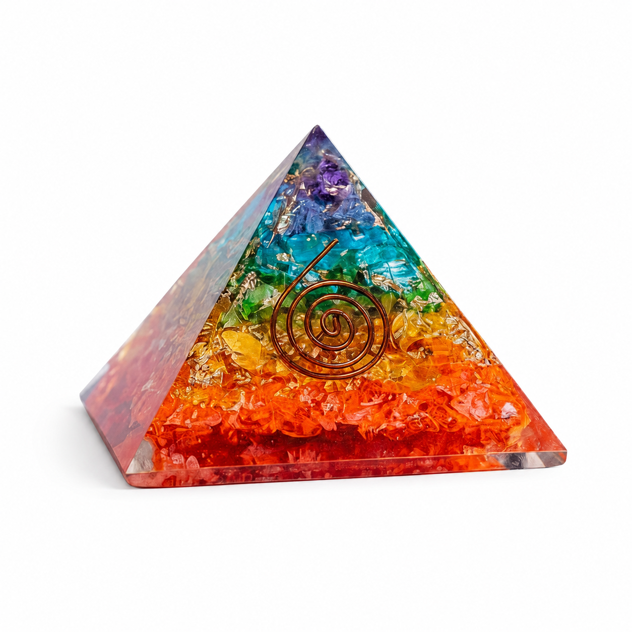 7 chakra stone orgonite pyramid with layered chakra crystals and copper spiral on clean white background by Journey of Atman.
