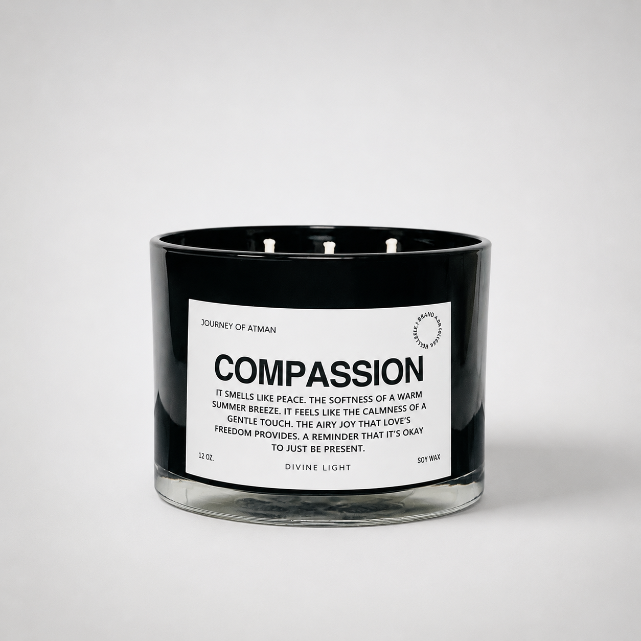 Compassion affirmation candle in black glass vessel with white label on clean white background supporting kindness, healing, and self-compassion.