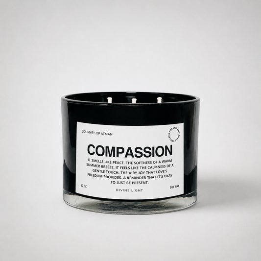 Compassion affirmation candle in black glass vessel with white label on clean white background supporting kindness, healing, and self-compassion.