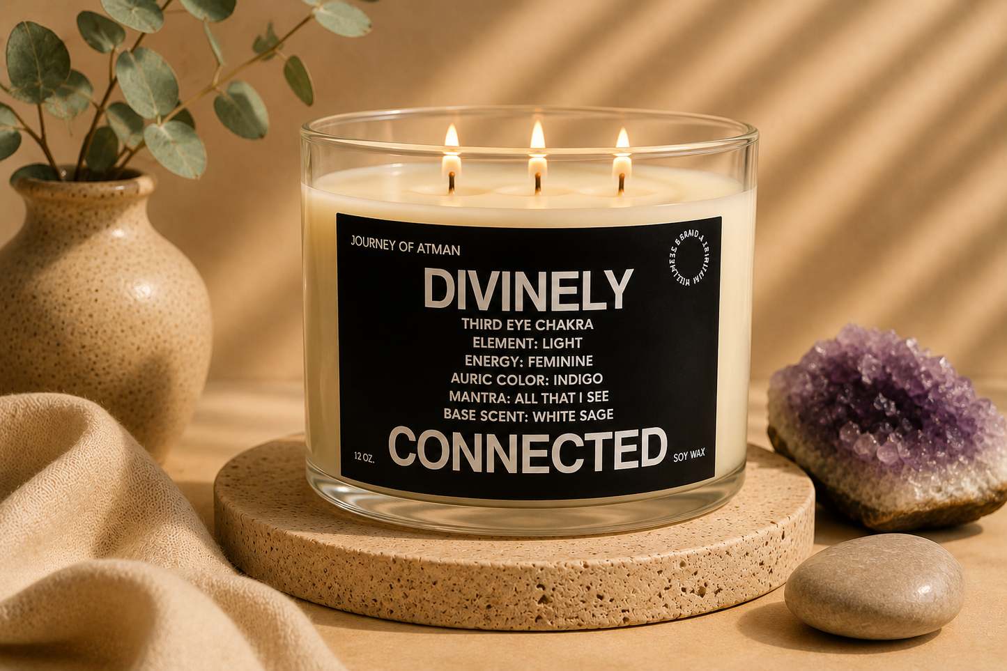 Divinely Connected third eye chakra candle by Journey of Atman styled in a calming wellness scene with amethyst crystal accents, natural stone textures, and warm candlelight.
