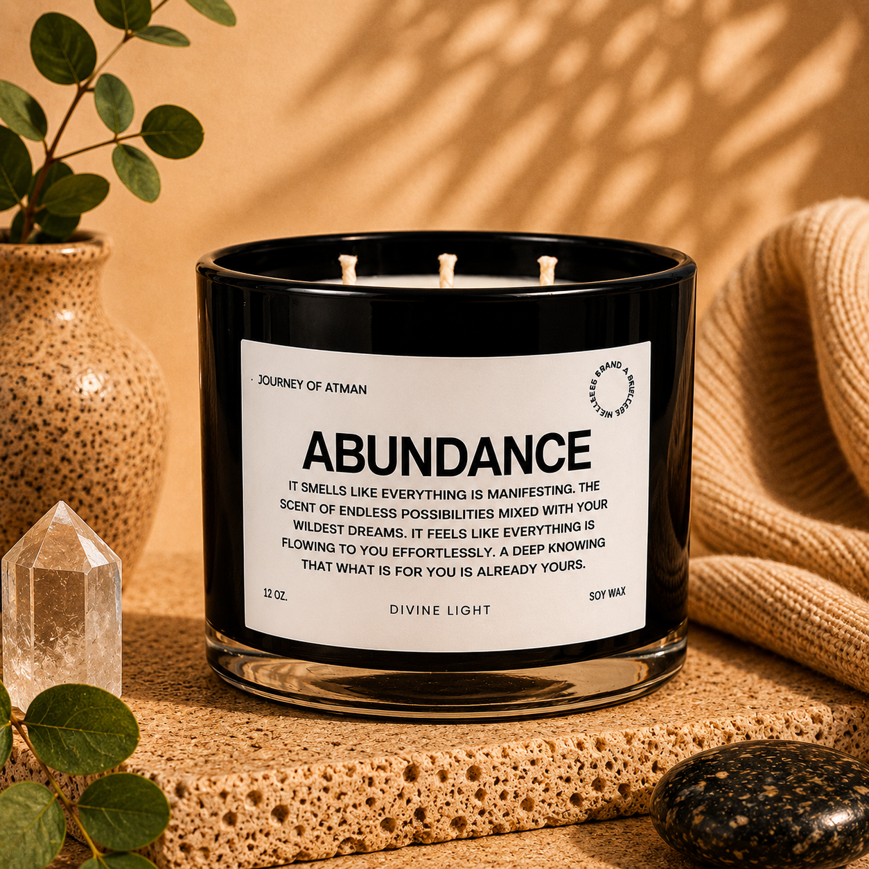 Abundance affirmation candle in warm lifestyle setting with crystal, eucalyptus, and soft neutral décor for manifestation and intentional self-reflection.