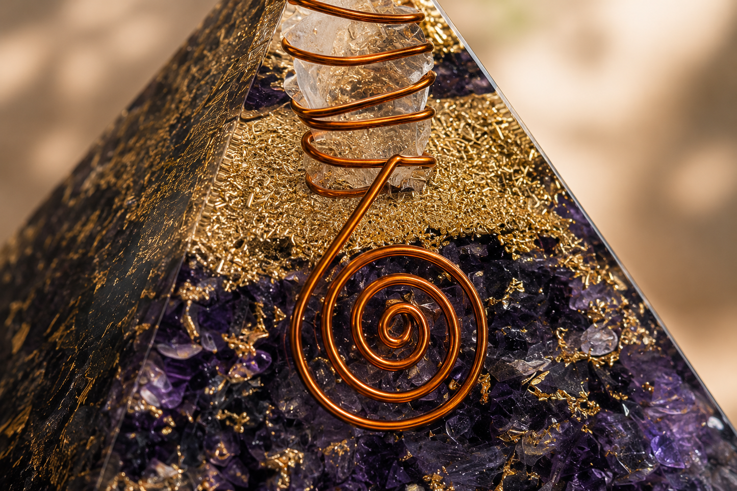 Close-up detail of amethyst orgonite pyramid featuring crystal texture, copper coil, and resin craftsmanship.