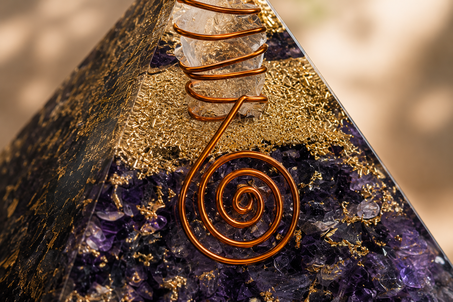 Close-up detail of amethyst orgonite pyramid featuring crystal texture, copper coil, and resin craftsmanship.