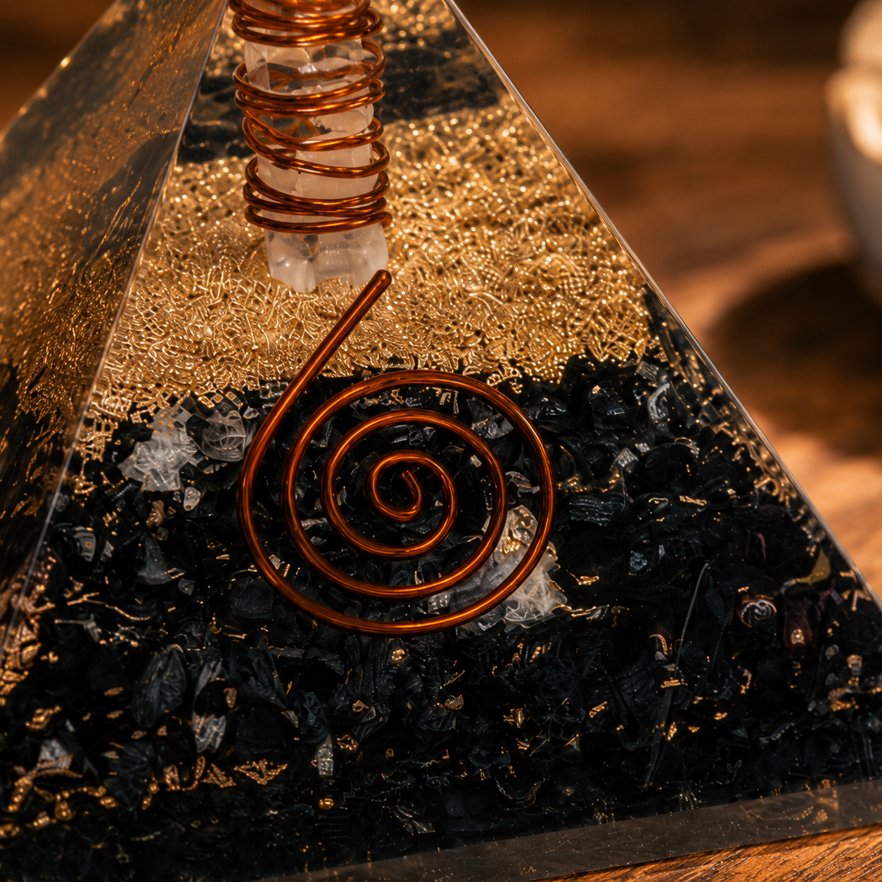 Close-up detail of black tourmaline orgonite pyramid featuring crystal texture, copper coil, and resin craftsmanship.