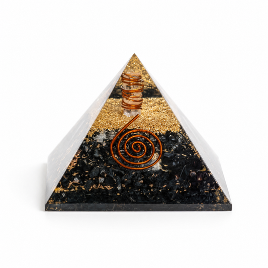 Black tourmaline orgonite pyramid with copper spiral and crystal layers on clean white background by Journey of Atman.