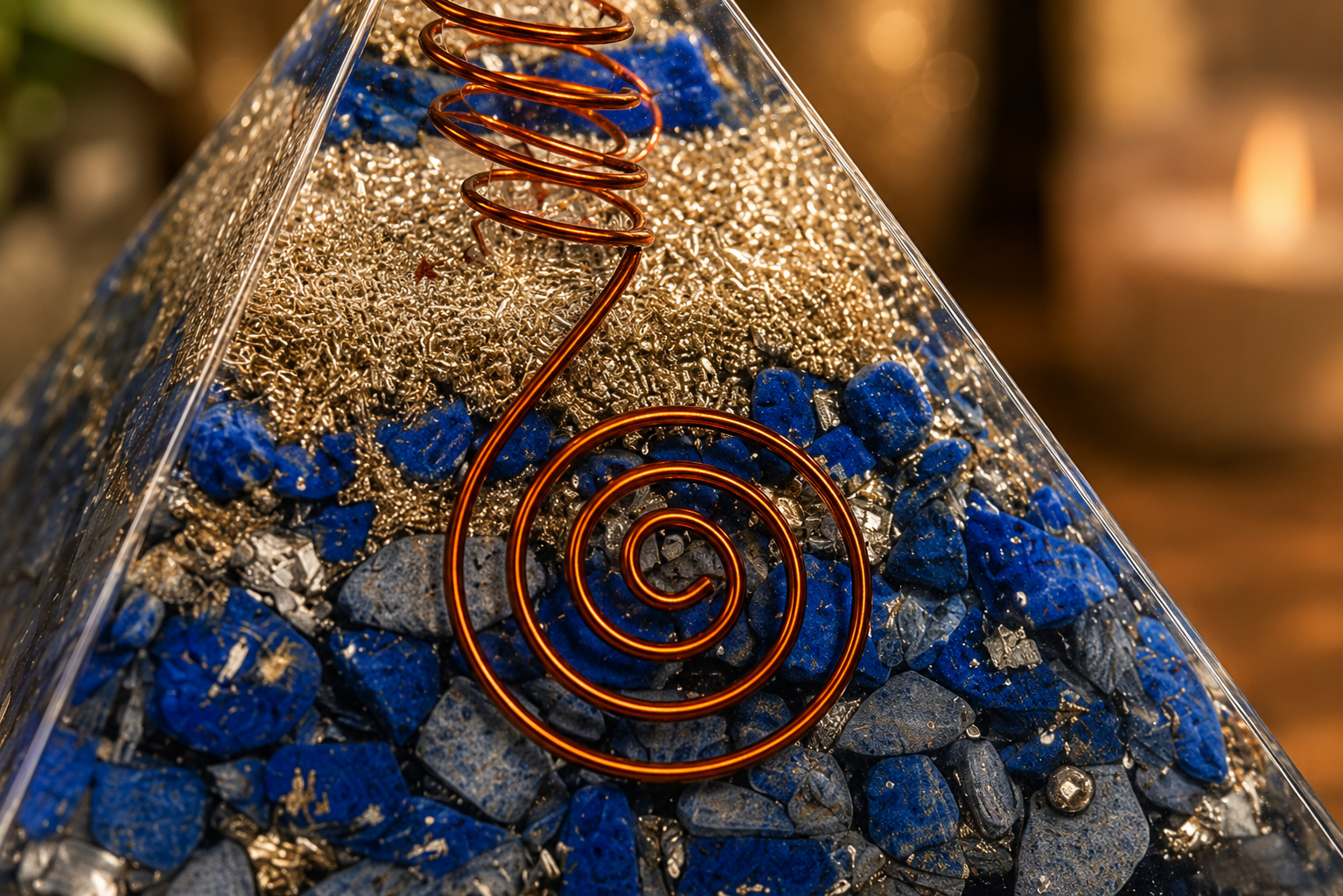 Close-up detail of lapis lazuli orgonite pyramid featuring crystal texture, copper coil, and resin craftsmanship.