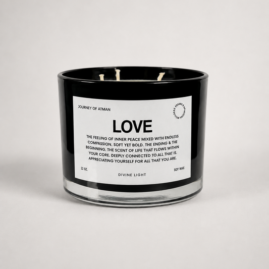Abundance affirmation candle in black glass vessel with white label on clean white background for manifestation and intentional self-reflection.