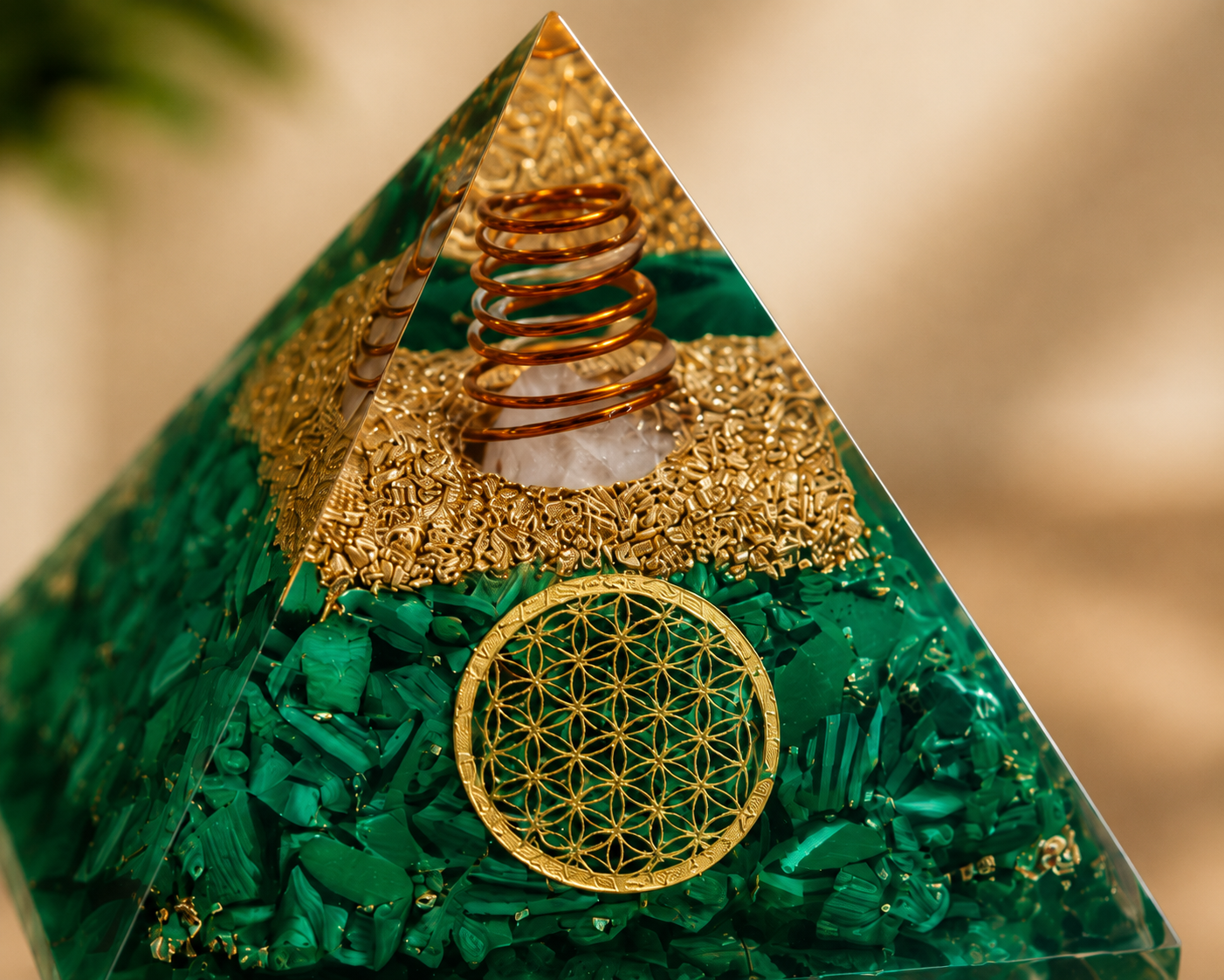 Close-up detail of malachite orgonite pyramid featuring crystal texture, copper coil, resin craftsmanship, and Flower of Life symbol.