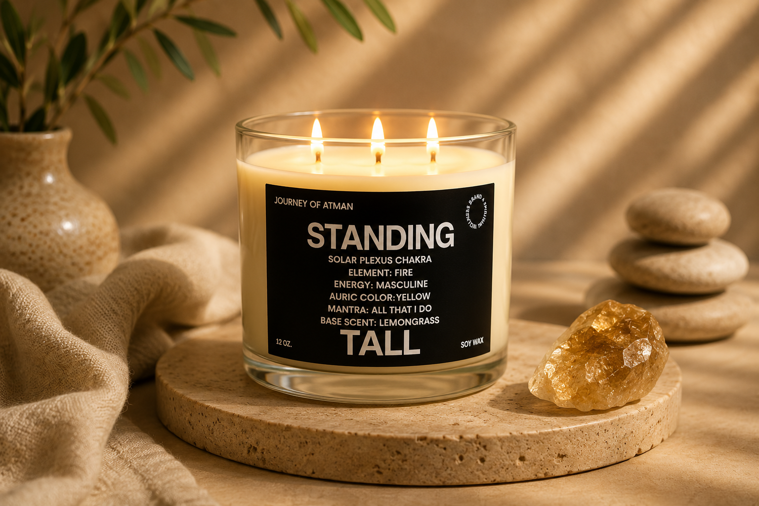 Standing Tall solar plexus chakra candle by Journey of Atman styled in a warm luxury wellness setting with golden crystal accents, natural stone pedestal, and soft ambient candlelight.
