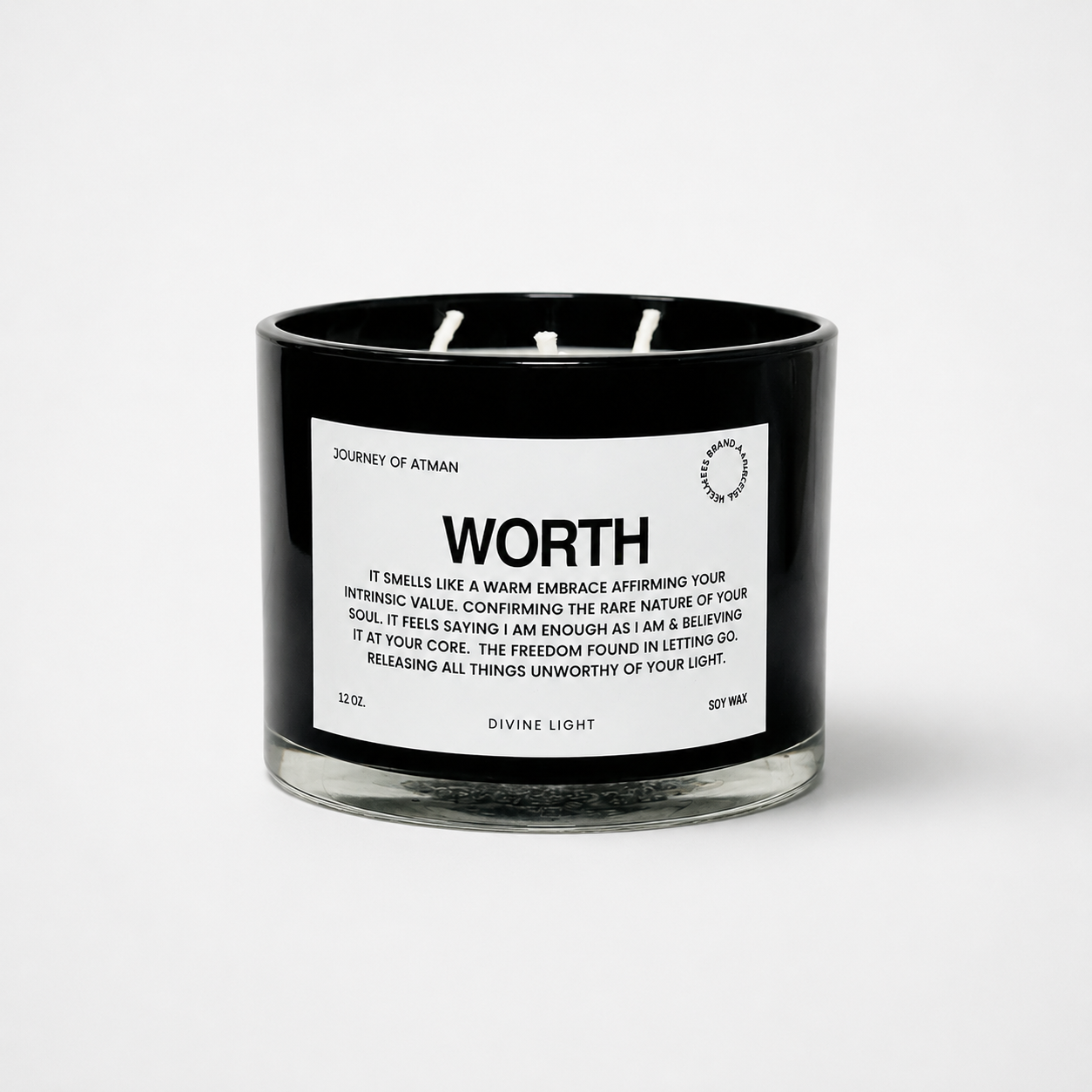 Worth affirmation candle in black glass vessel with white label on clean white background supporting self-worth and confidence.
